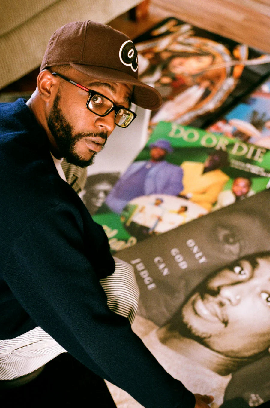 Nakari Johnson surrounded by archived hip-hop magazines