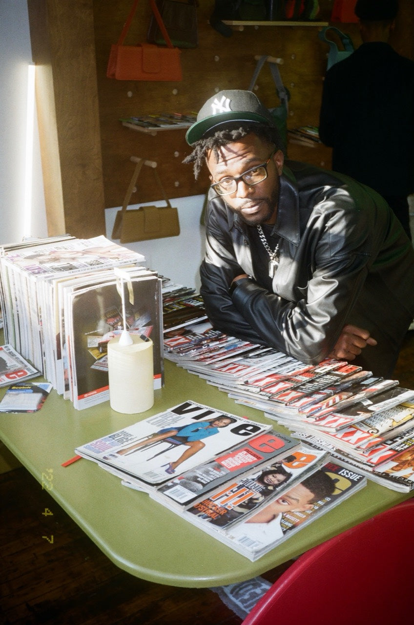 Nakari Johnson with archived magazines displayed at EDAS Studios