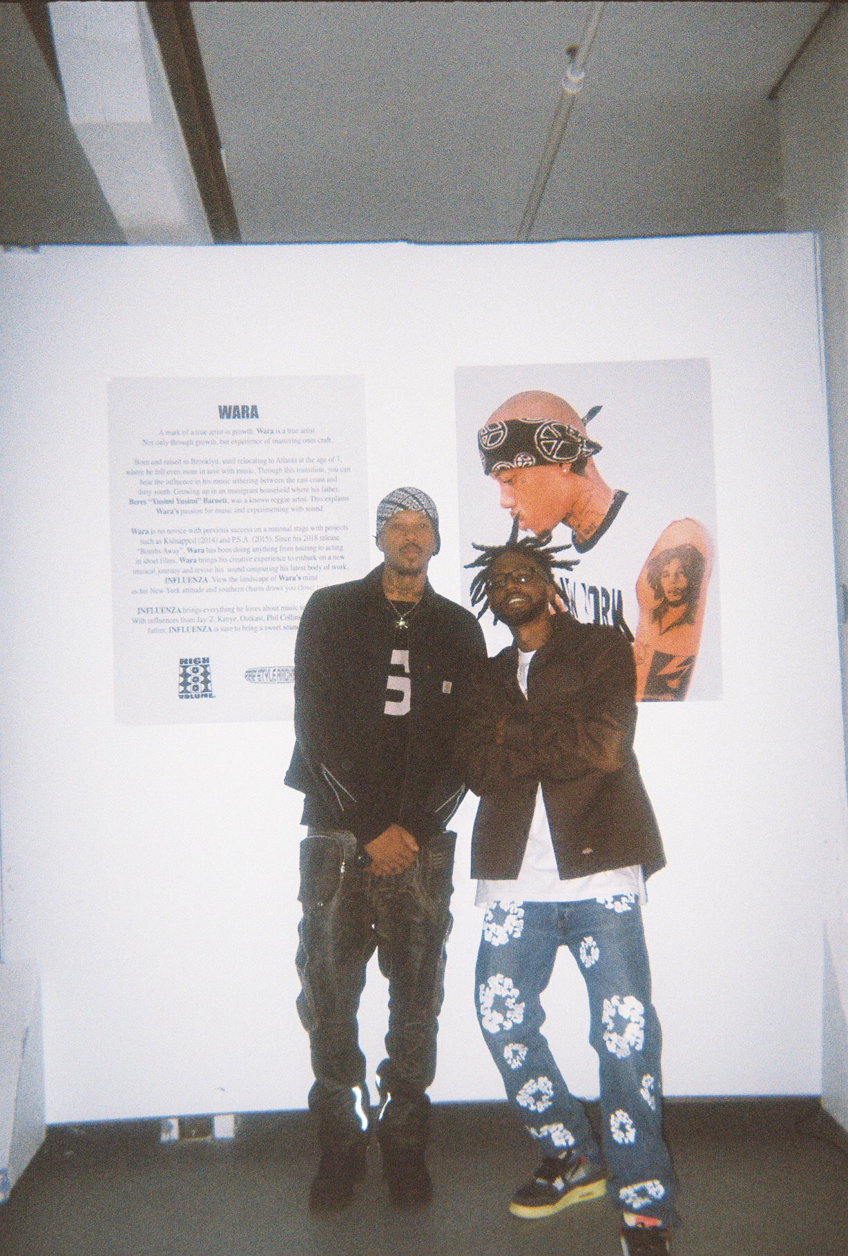 Nakari Johnson and Wara standing in front of the INFLUENZA write-up display